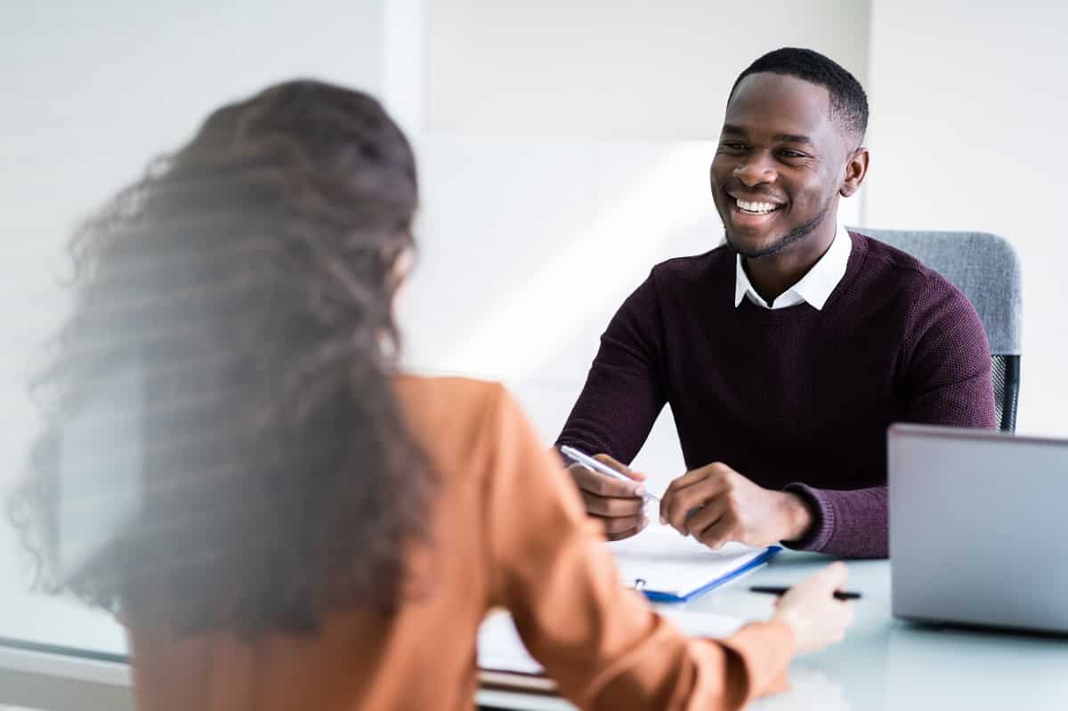 Manager and employee having meeting in office discussing performance and feedback