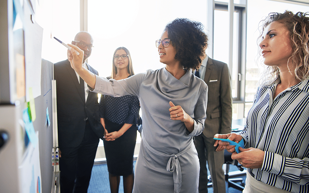 woman presenting something to her team